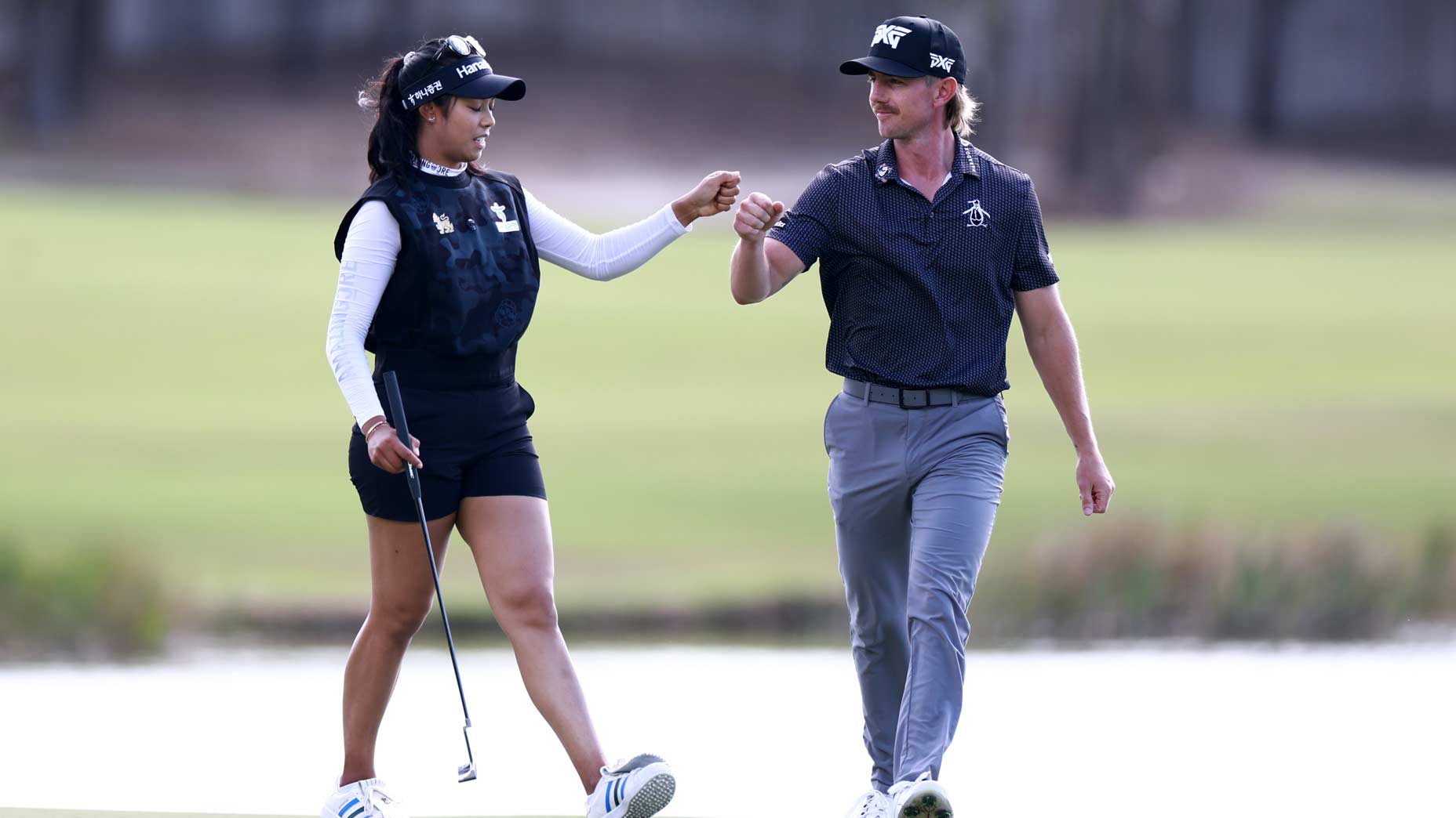 Jake Knapp and Patty Tavatanakit fist bumb at the Grant Thornton.