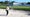 golfer hits greenside bunker shot